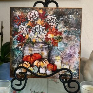 May include: A watercolor painting on canvas featuring a white hydrangea bouquet in a rustic vase with pumpkins and candles. The painting has a fall theme with autumn leaves and a textured background.
