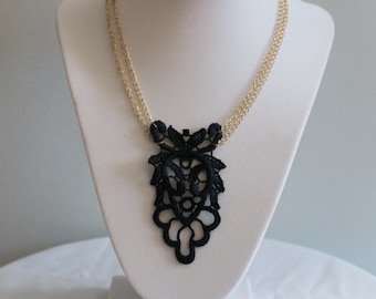 Necklace with lace pendant.