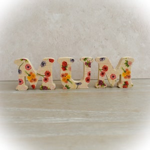 Adorno floral de la palabra MUM, letras independientes