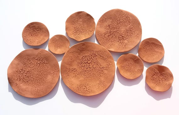 Large-scale terracotta wall tile sculptures made to order — earthy, architectural, and the kind of statement wall piece that stops guests mid-sentence.
