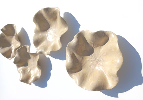 Made-to-order porcelain tulips that mount directly on your wall — it's 3D floral wall sculpture, not a print, each petal individually hand-formed.
