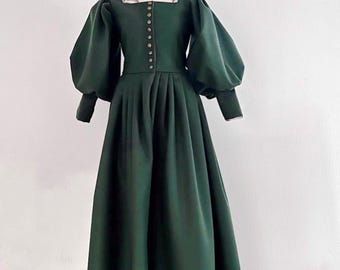 16th century renaissance dark green wool dress with wide puffed sleeves long fitted cuffs pleated skirt and front metal button closure gown