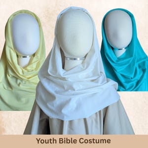 May include: Three head coverings for a youth Bible costume displayed on white mannequin heads. The head coverings are in solid light yellow, white, and bright turquoise colors. The text "Youth Bible Costume" is printed at the bottom.