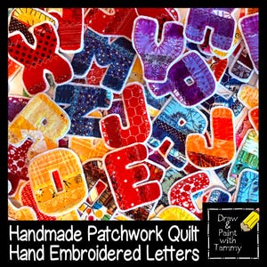 May include: Handmade patchwork quilt letters in various colors, including red, orange, yellow, blue, and purple. Each letter is hand embroidered and features unique fabric patterns. The letters are arranged in a colorful, artistic display.