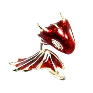 May include: A red dragon ring with silver wings and a sparkly finish. The dragon's head is facing forward with its mouth closed.
