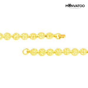 The Golden Constellar Bracelet on a flat surface showing both ens sides of the bracelet.