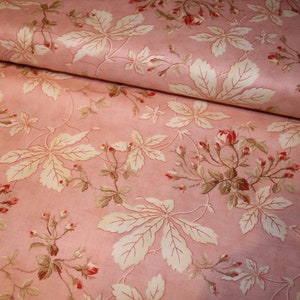May include: Pink fabric with a white and brown floral pattern. The pattern features leaves and small pink flowers.