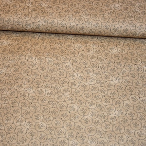 May include: A beige fabric with a repeating pattern of small, dark brown circles containing a stylised floral design.