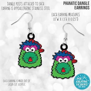 May include: A pair of green, blue, pink, and red dangle earrings featuring a cartoon character with a red hat. Each earring measures 1.0 inches wide by 1.3 inches high by 0.125 inches deep. The earrings are made of laser cut acrylic and have hypoallergenic stainless steel posts.