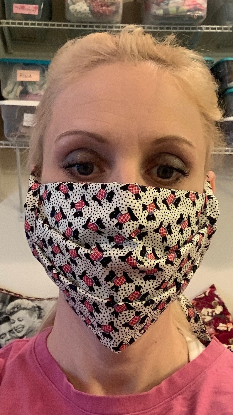 Handmade fabric pleated face mask that ties behind the head. Etsy