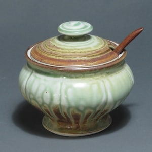 Lidded sugar jar with green ash and rust glazes