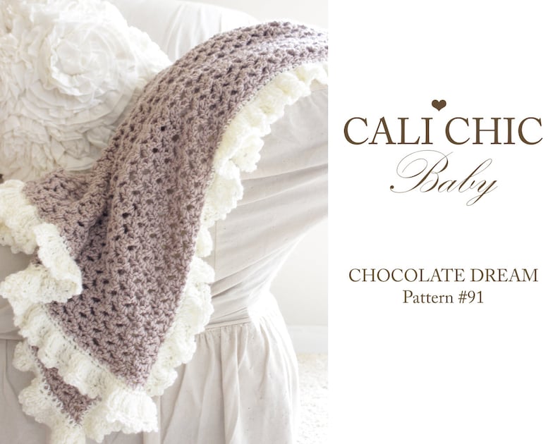 May include: A crocheted baby blanket in a light brown color with a white crocheted lace trim. The blanket is draped over a white chair. The text on the image reads 'Cali Chic Baby', 'Chocolate Dream', and 'Pattern #91'.