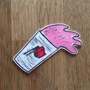 May include: A pink liquid spills out of a white paper cup with a red and black logo. The logo has a stylized image of a cup with a straw.
