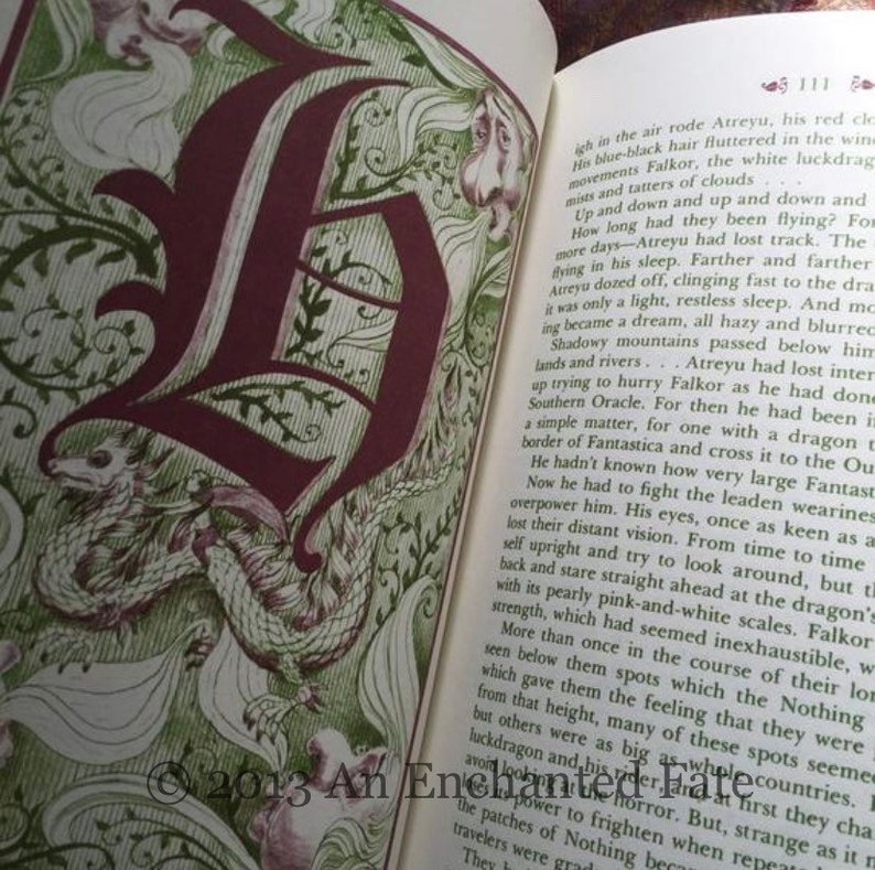 Photo showing the inside of The Neverending Stoy book, red and green illustration/illustrated letter at the beginning of each chapter, and red and green text throughout the book