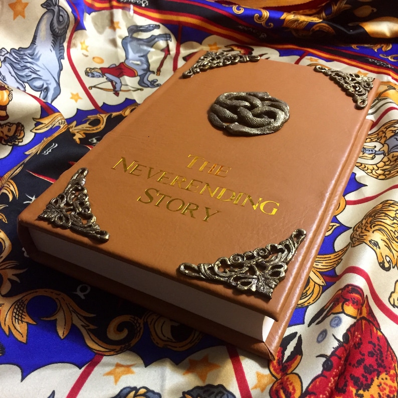 The Neverending Story leatherbound special illustrated edition lying on top of colorful silk table cloth