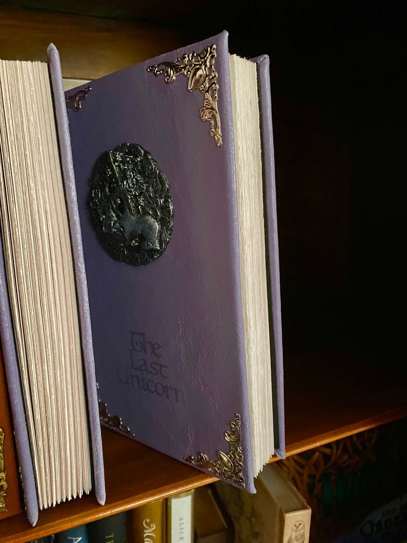Photo shows two copies of The Last Unicorn book, details of the deckled edge pages