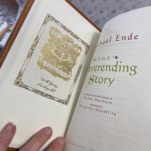 Photo showing where the custom bookplate (gold embossed, antique border on parchment paper) opposite The Neverending Story title page, author, illustrator, publisher