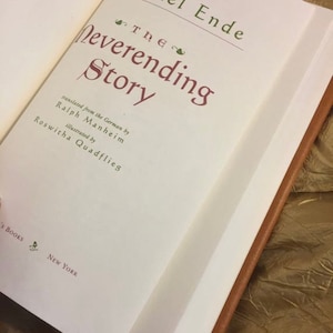 Photo of the title page of The Neverending Story, author, illustrator, publisher. Showing that it is actually the book and not just blank like many others for sale