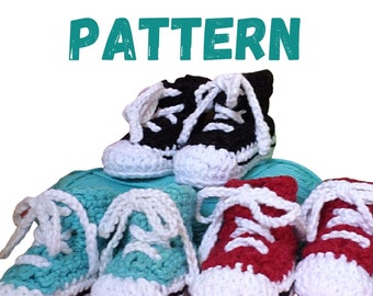 May include: Crocheted baby shoes in the shape of high-top sneakers. The shoes are in black, red, and turquoise.