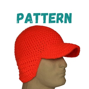 May include: A bright orange crocheted hat with a visor and ear flaps. The hat is made with a simple stitch pattern and has a casual, sporty look.