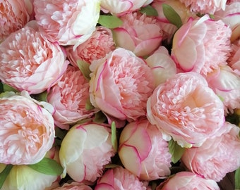 May include: A bouquet of pink peonies with a soft, delicate texture. The flowers are arranged in a cluster, creating a beautiful and romantic display.