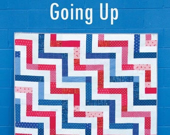 May include: A quilt pattern called "Going Up" featuring a zig-zag design in red, blue, and white fabrics. The pattern is a fat quarter quilt in 4 sizes. The pattern is from Cluck Cluck Sew and is number 179.