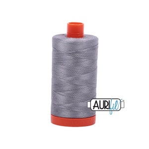 May include: A spool of gray thread with an orange plastic bobbin and the word "Aurifil" printed on a blue label.