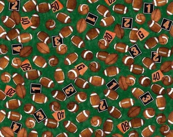 May include: Green fabric featuring a repeating pattern of brown American footballs, yard markers, and numbers. The footballs have white stripes and are scattered across the fabric. Yard markers display numbers like 20, 40, and 50.