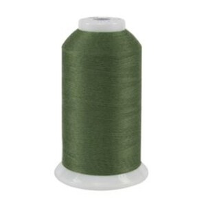 May include: A spool of dark green thread for sewing or embroidery.