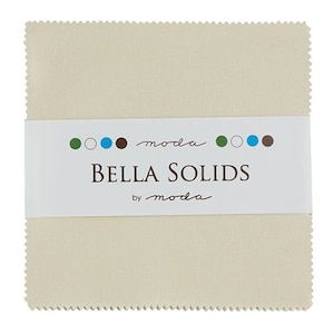 May include: A cream-colored fabric square with a white label that reads "moda Bella Solids by moda" with a row of colored circles above the text.