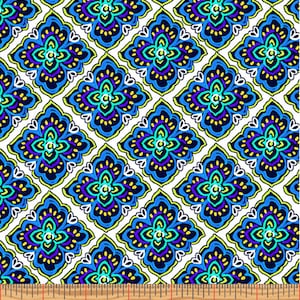May include: A fabric with a repeating pattern of diamond-shaped floral designs. The designs feature blue, teal, purple, and yellow accents on a white background. The ruler at the bottom shows measurements in inches.