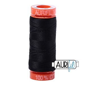 May include: A spool of black thread with an orange label that reads "Aurifil 100% Cotton".