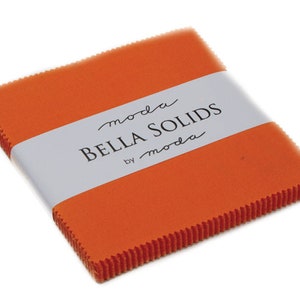 May include: A pack of orange fabric squares labeled "moda Bella Solids by moda".