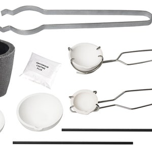 May include: A metal melting kit with a gray crucible, white ceramic crucibles, tongs, and a bag of flux.  The bag of flux has the text "Anonymous Casting Flux" printed on it.