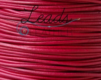 May include: Close-up of a spool of deep red leather cord. The cord is tightly wound, creating a textured surface. The text "Leads Leather" is visible in a stylized font, with a small blue accent.