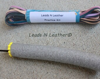 May include: A leather cord practice kit with a roll of multi-colored leather cords and a grey foam practice tool with a black needle and yellow beads.