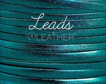 May include: Teal leather cord wound into a spool. The cord is smooth and shiny with a metallic finish. The label "Leads n Leather" is visible on the spool.