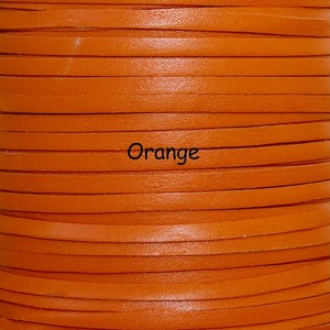 May include: Close-up of a spool of orange leather strips. The strips are stacked horizontally, revealing a textured surface. The word "Orange" is printed in black across the center of the image. This material is suitable for crafting.