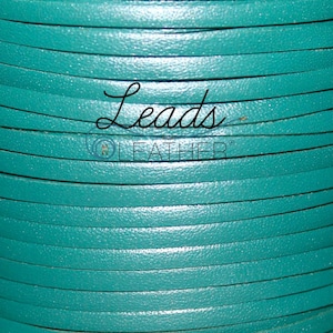May include: A close-up of a spool of teal leather cord. The cord is smooth and has a slight sheen. The text "Leads Leather" is visible on the spool.
