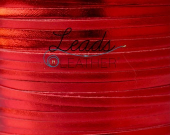 May include: A close-up of a spool of red leather cord. The cord is shiny and has a metallic finish. The spool is labeled "Leads Leather".