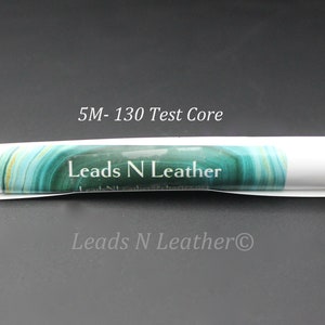 May include: A roll of black cord labeled "5M-130 Test Core" and "Leads N Leather" on a white label with a green and blue marble design.