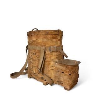 May include: A vintage wooden backpack with a woven basket design and leather straps. The backpack has a small compartment on the side.