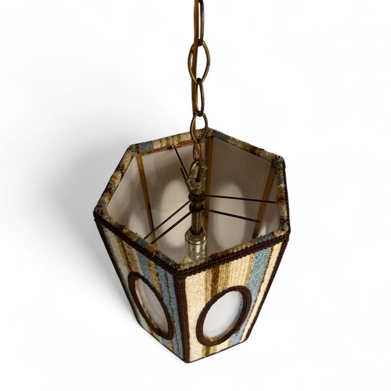 Top-down view of a vintage swag lamp with hexagonal shape and oval cutout, hanging on chain against a white background.