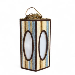 Vintage swag lamp with hexagonal shape and oval cutout, hanging on chain against a white background.