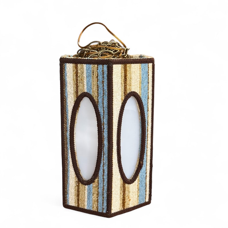 Vintage swag lamp with hexagonal shape and oval cutout, hanging on chain against a white background.