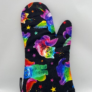 May include: Black oven mitt with a rainbow unicorn cat pattern. The cats have wings and are surrounded by stars.