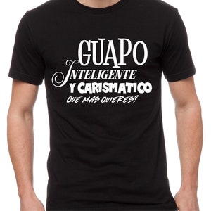 May include: Black t-shirt with white text that reads "GUAPO INTELIGENTE Y CARISMATICO QUE MAS QUIERES?"