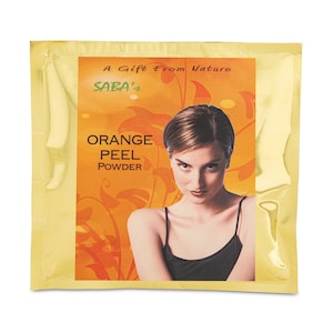 May include: A gold foil packet with a woman on the front. The packet says "A Gift From Nature" and "SABA's" in a stylized font. The text "ORANGE PEEL POWDER" is also on the packet.
