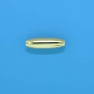 May include: A gold-colored, oblong bead with a smooth, reflective surface. The bead is centered on a solid blue background. The bead's shape is symmetrical, with a slight indentation at the center.