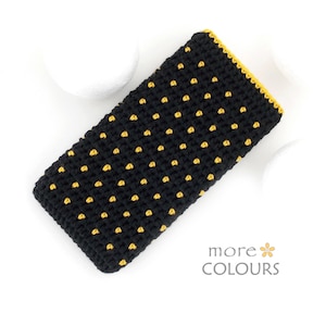 May include: Black crochet case with yellow polka dots and a yellow border. The case is rectangular and appears to be handmade. The words "more COLOURS" are in the bottom right corner.